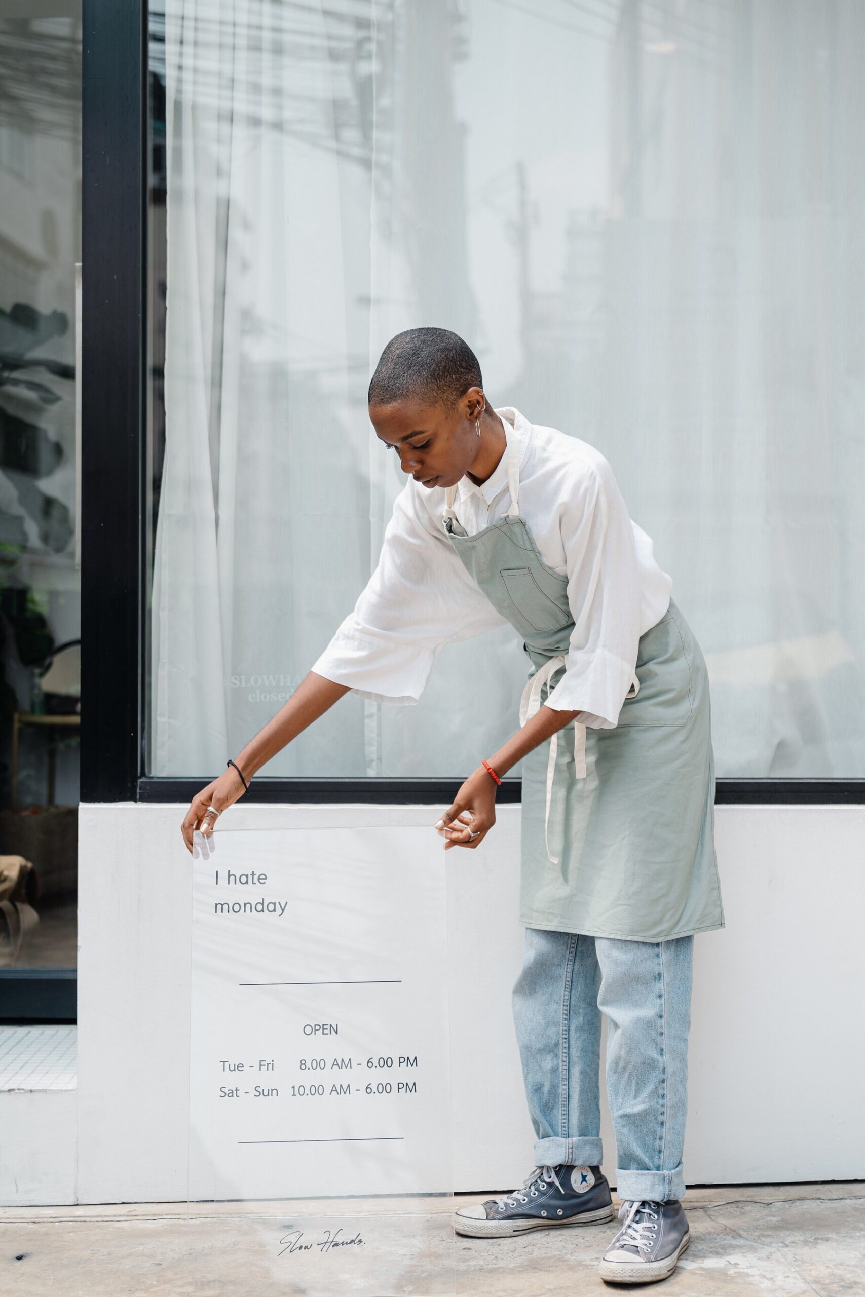 woman posting Open for Business schedule